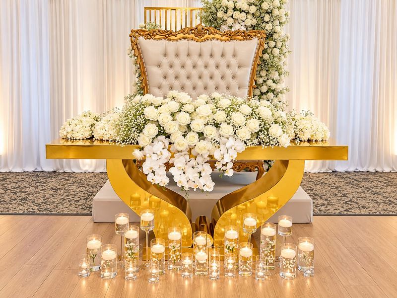 Gold sweetheart table with white throne and florals