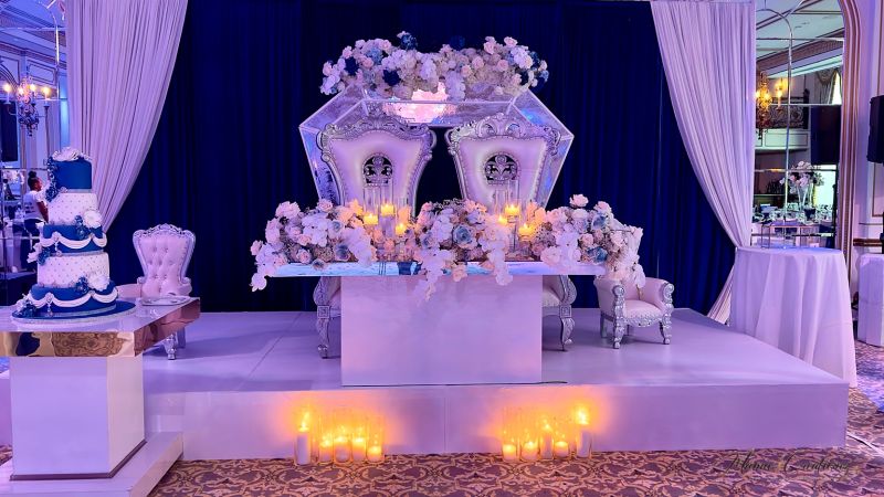 Reception hall with blue drape and a custom dance floor