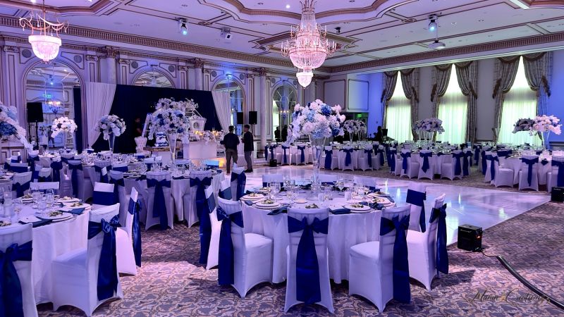 Reception hall with blue drape and a custom dance floor