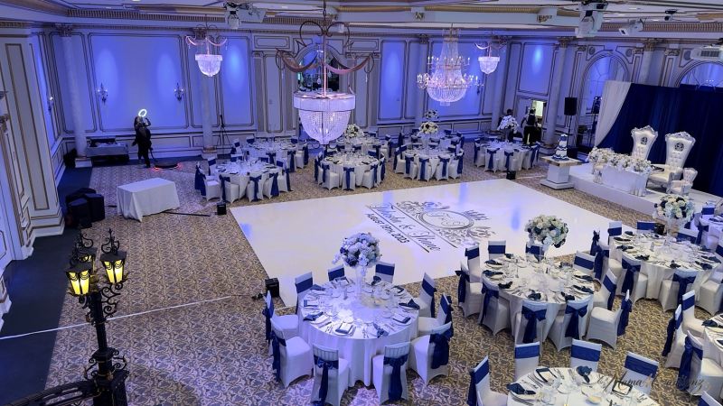 Reception hall with blue drape and a custom dance floor