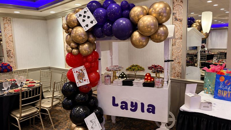 Sweet 16 Poker Lounge candy cart with balloon garland