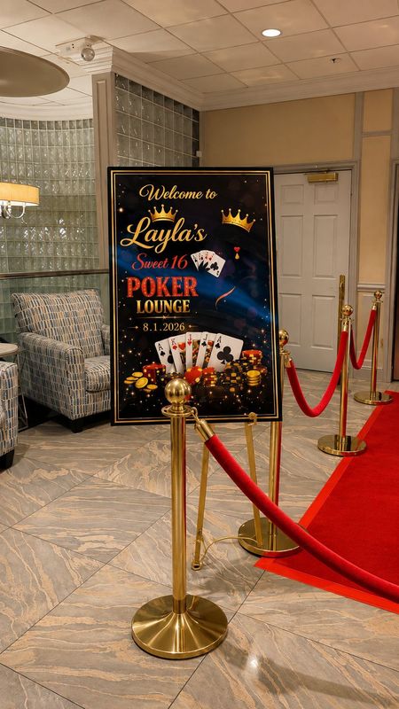 Sweet 16 welcome sign with gold stanchions and red carpet