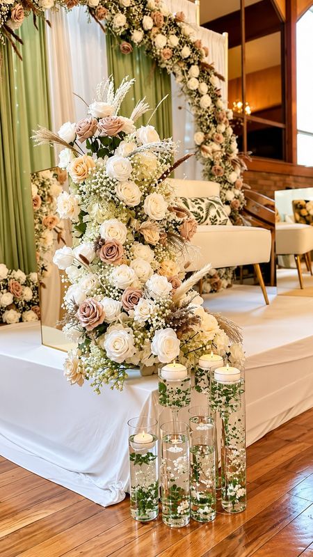 Floral arch with styled loveseat and cascading florals